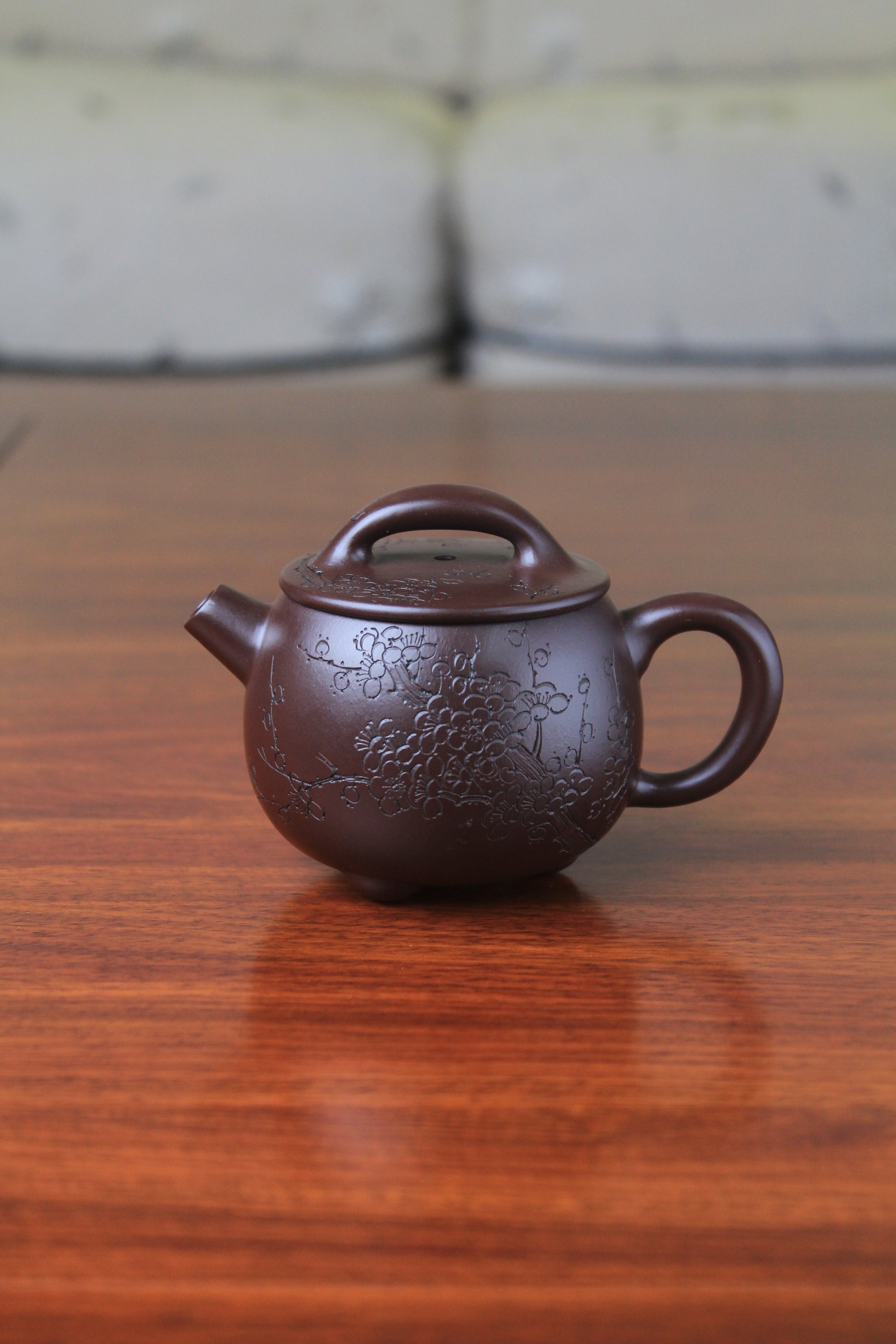 Cute chinese teapot handmade with purple clay on the table