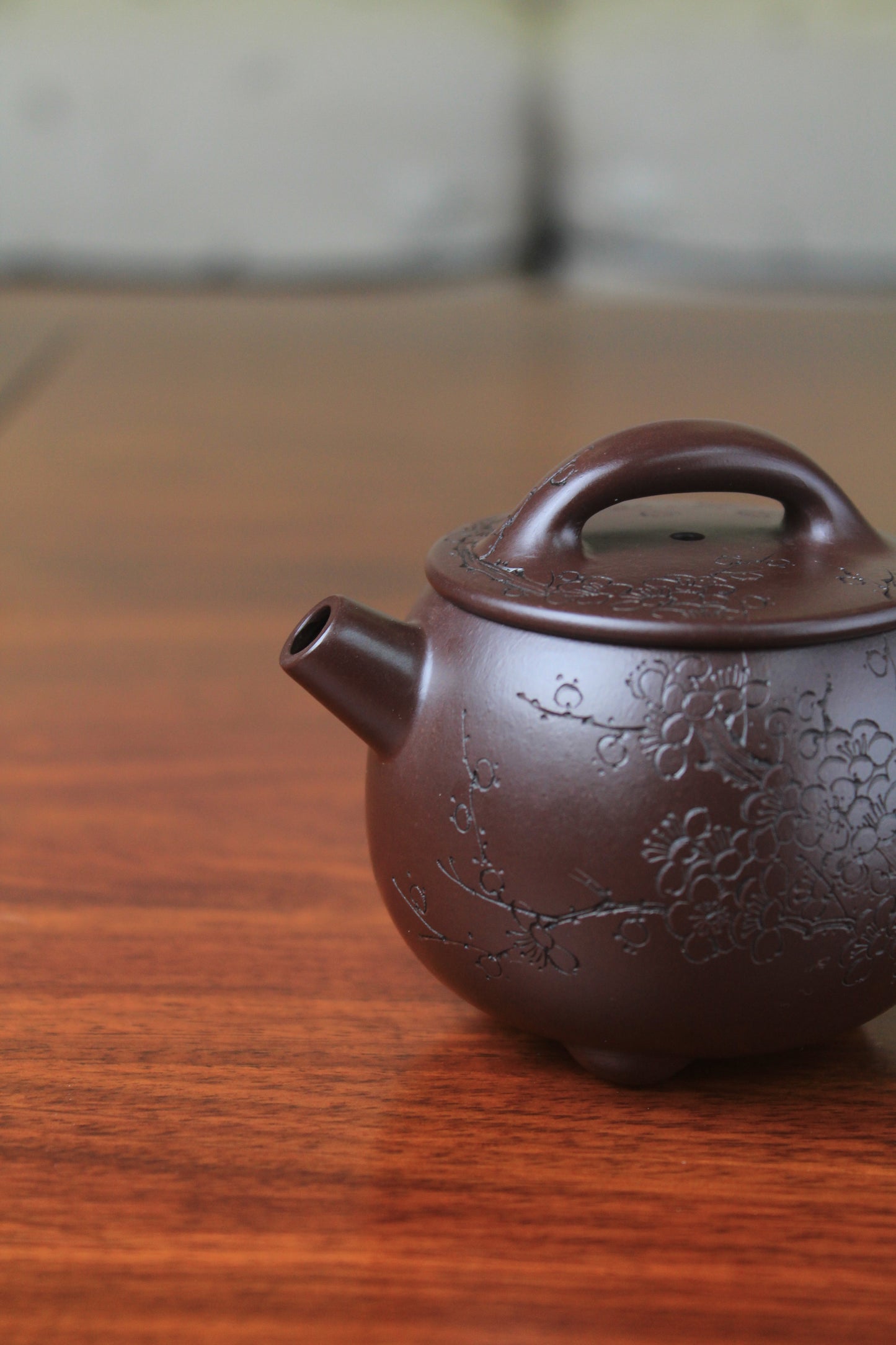Spout of chinese teapot handmade with purple clay on the table