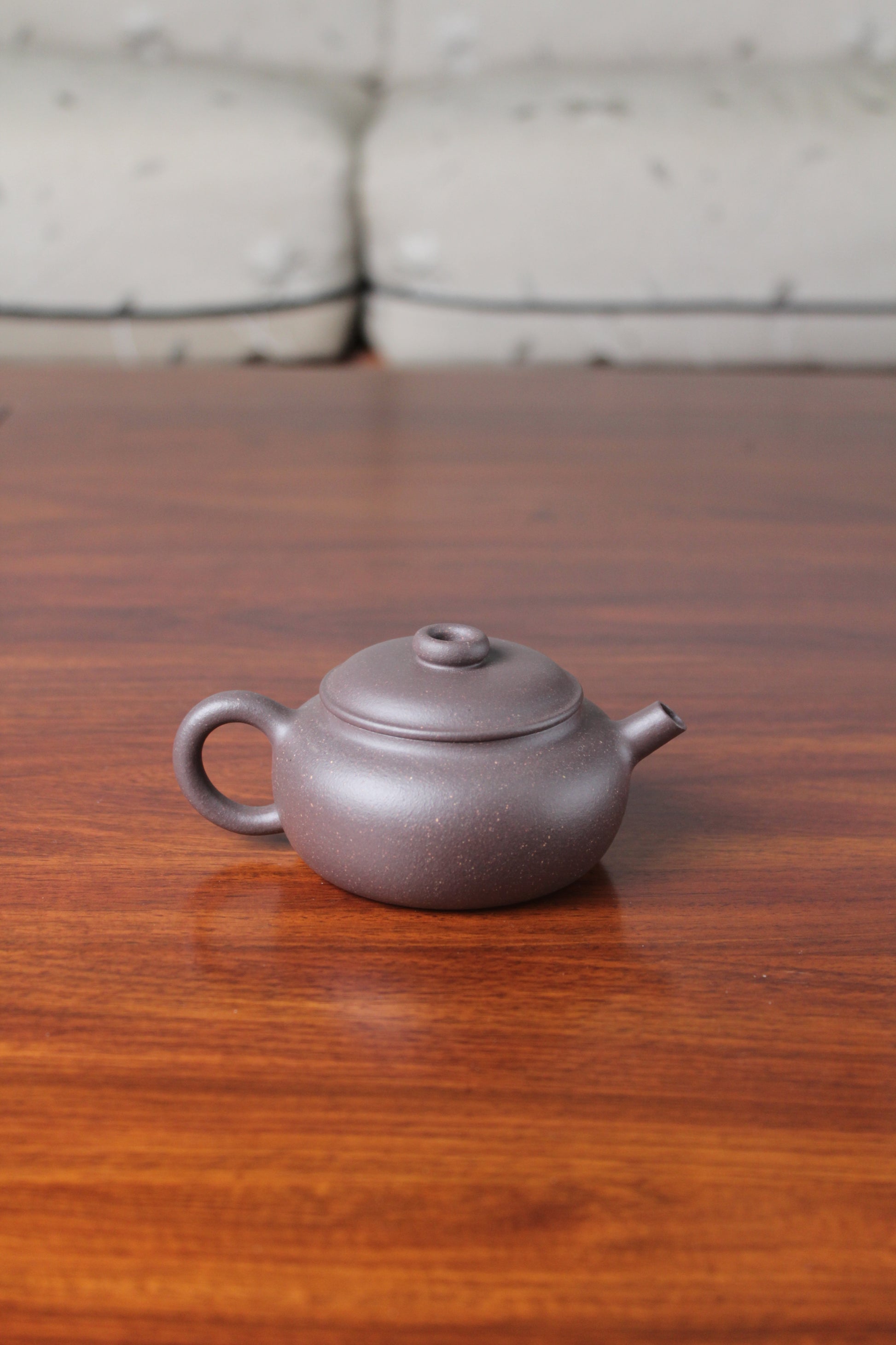 Back view of the Chinese teapot on the table