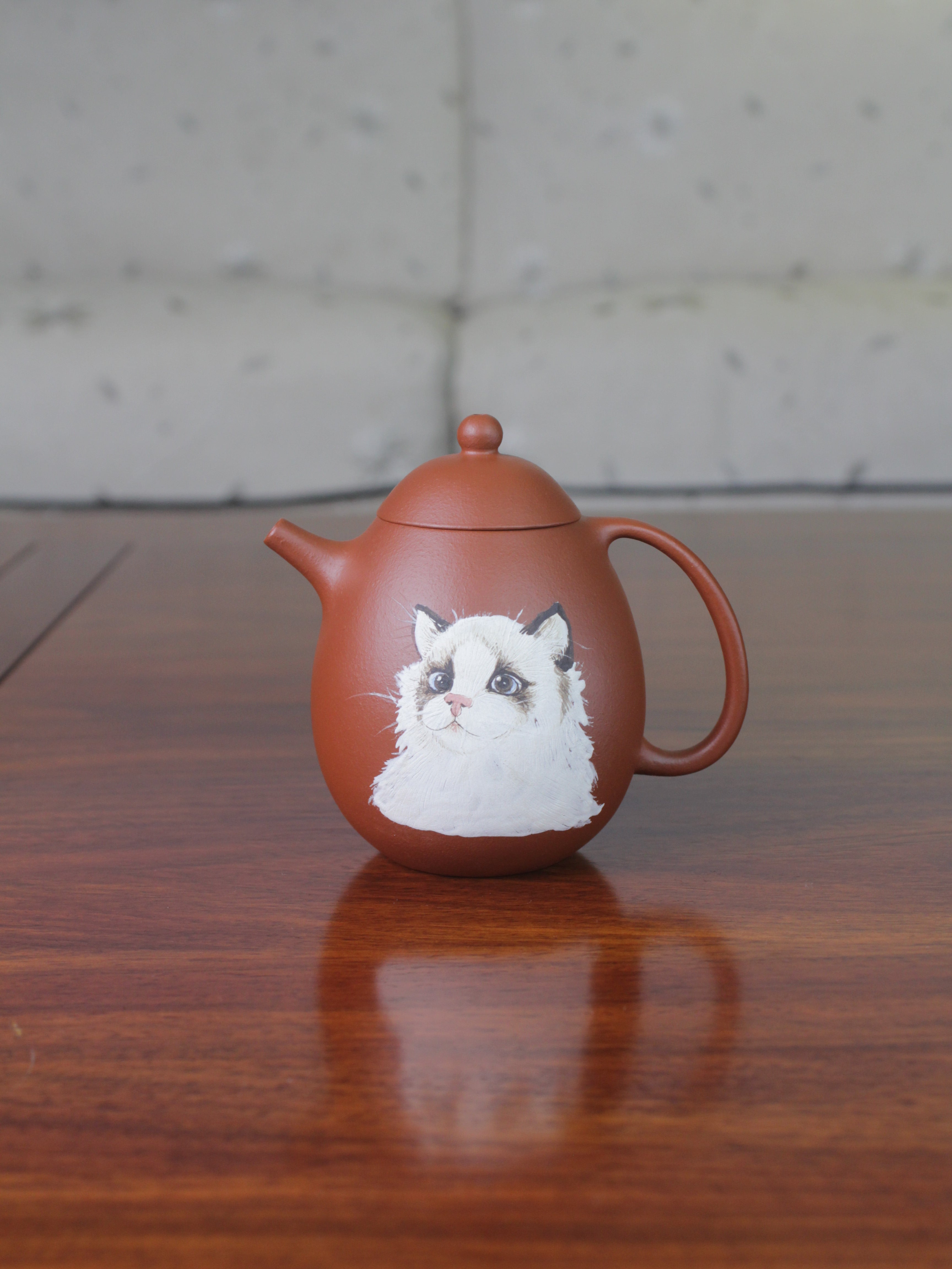Chinese teapot on the table. This yixing clay teapot was handmade with authentic purple clay zhu ni.