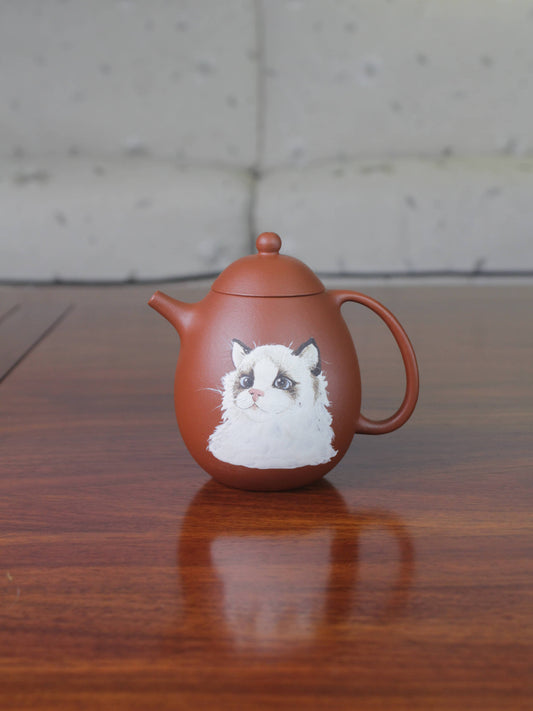 Chinese teapot on the table. This yixing clay teapot was handmade with authentic purple clay zhu ni.