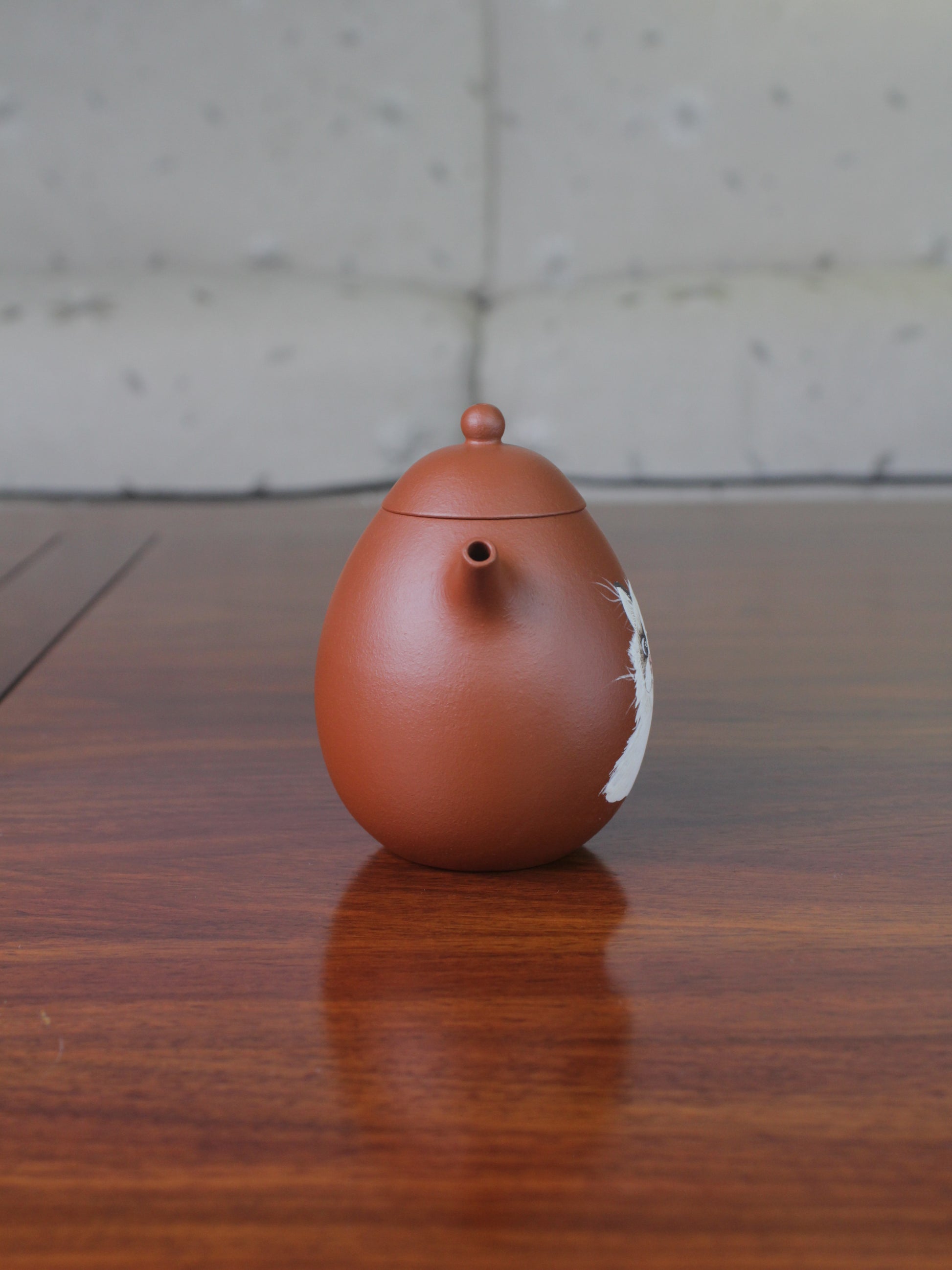 Front view of the chinese teapot. This yixing clay teapot was handmade with authentic purple clay zhu ni.