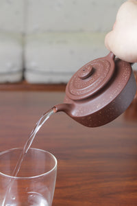 Pour of the collectible teapot handmade by teapot artist