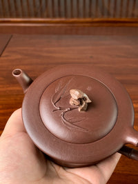Pick up the teapot and observe its details from every angle