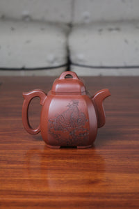back of the collectible teapot from teapot artist on the table