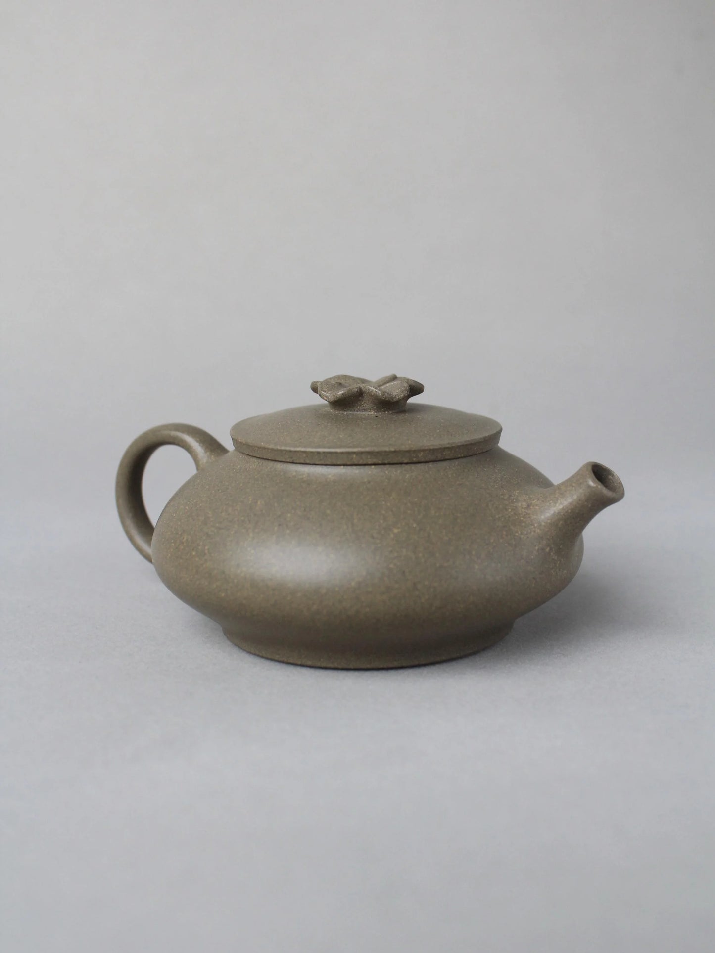 collectble teapot named flower on the table - left view