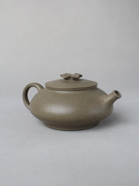 collectble teapot named flower on the table - left view