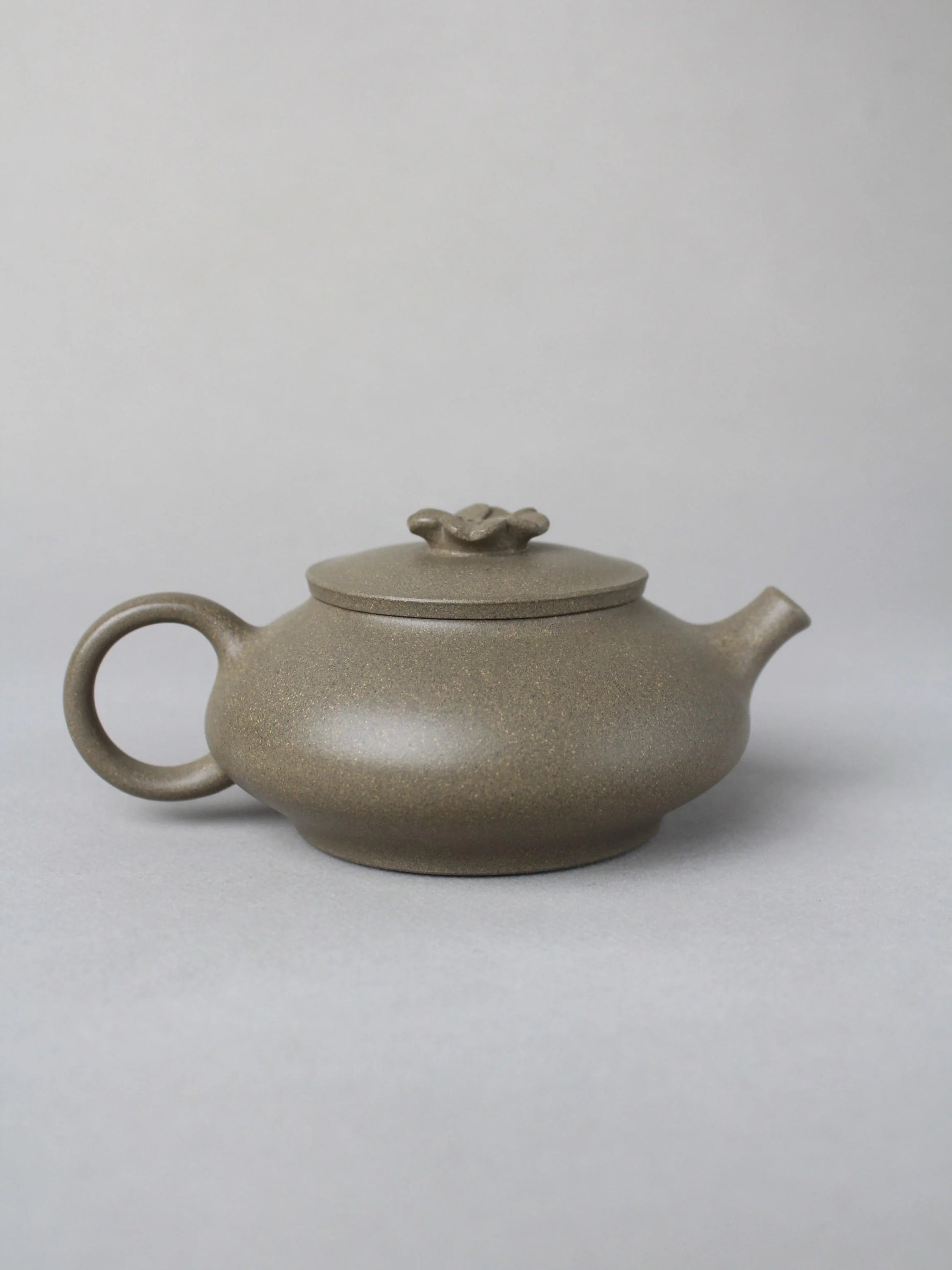 collectble teapot named flower on the table - back view