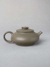 collectble teapot named flower on the table - back view