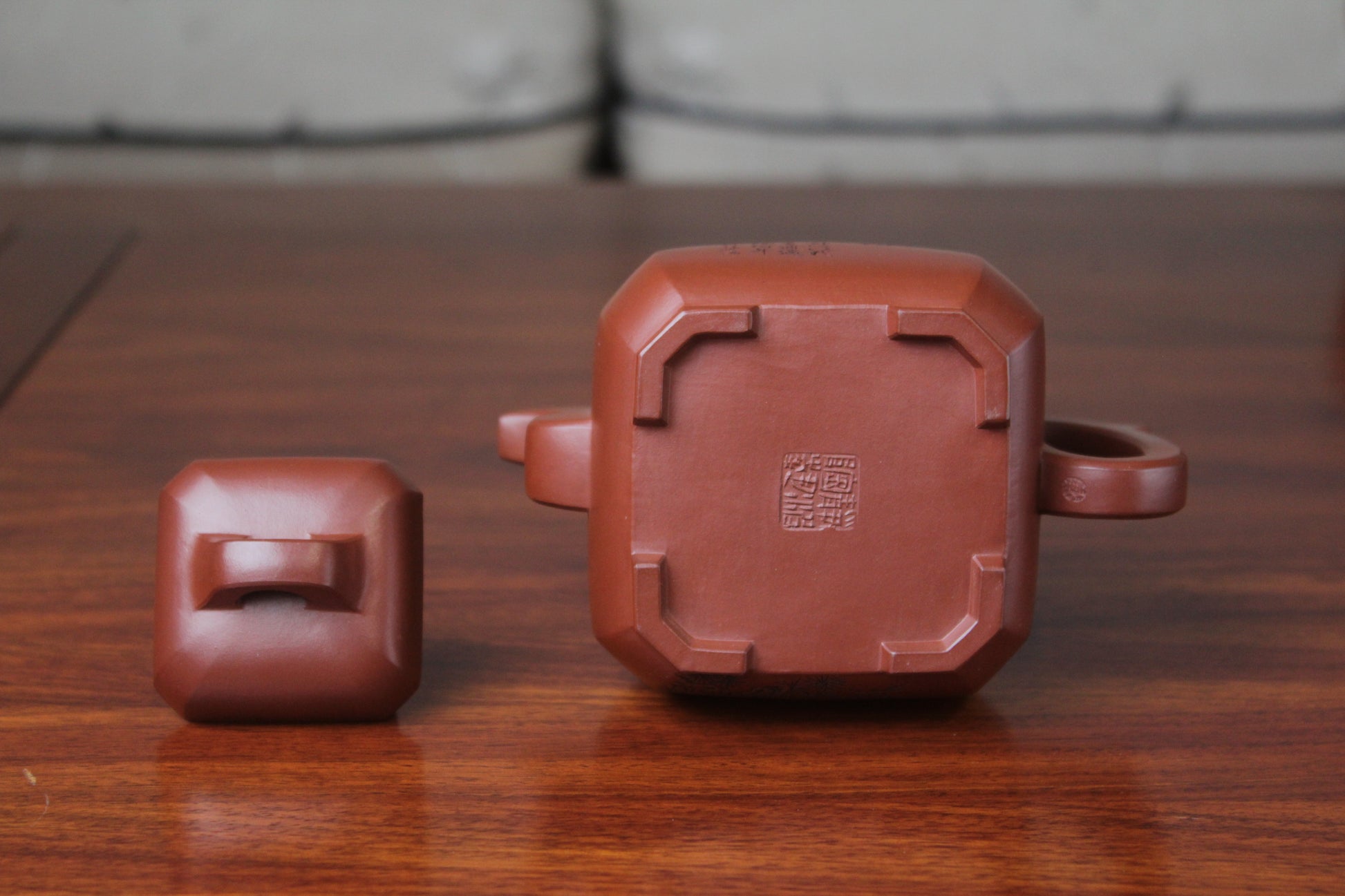 bottom of the collectible teapot from teapot artist on the table