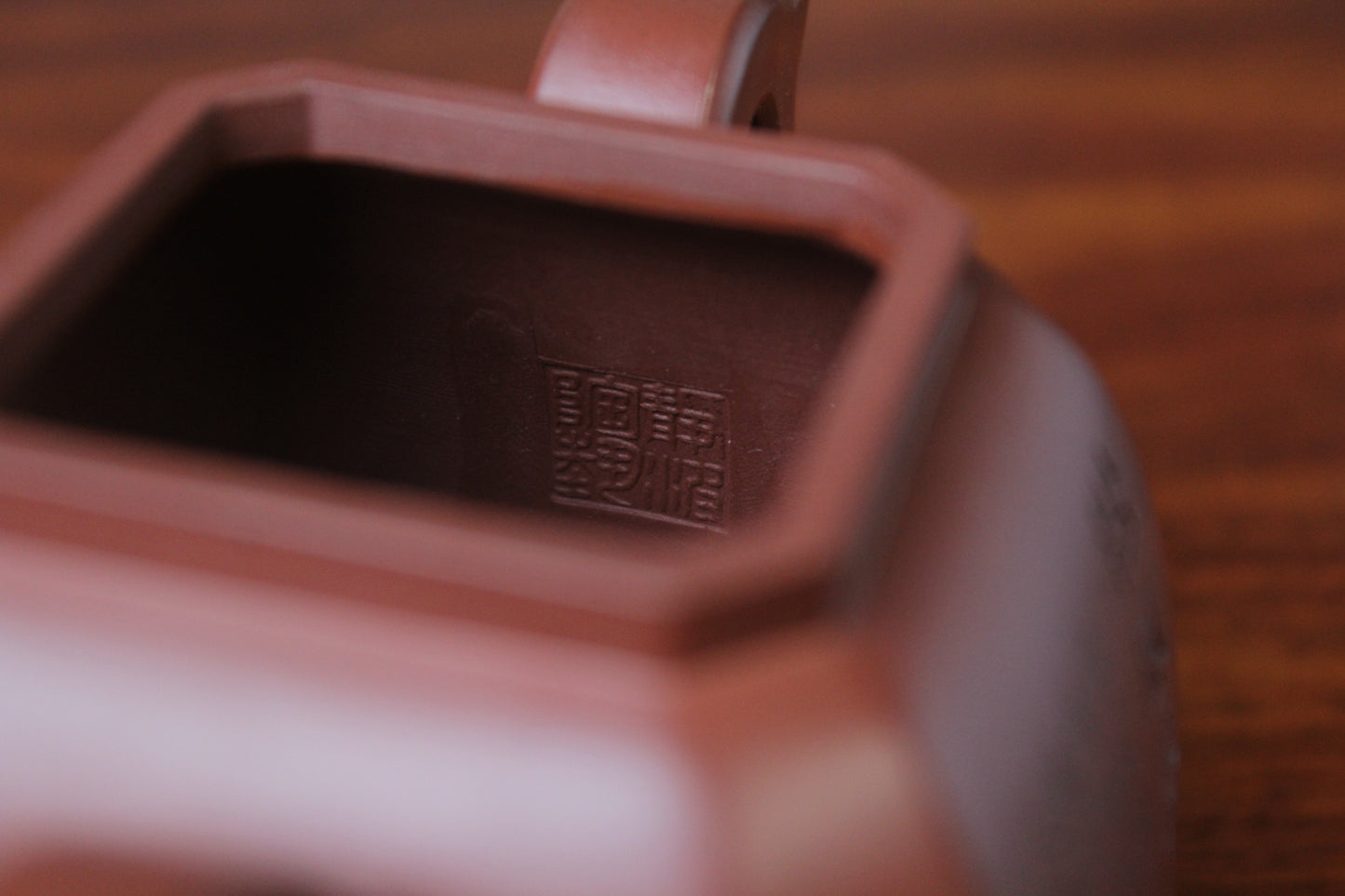 marks of the collectible teapot from teapot artist on the table