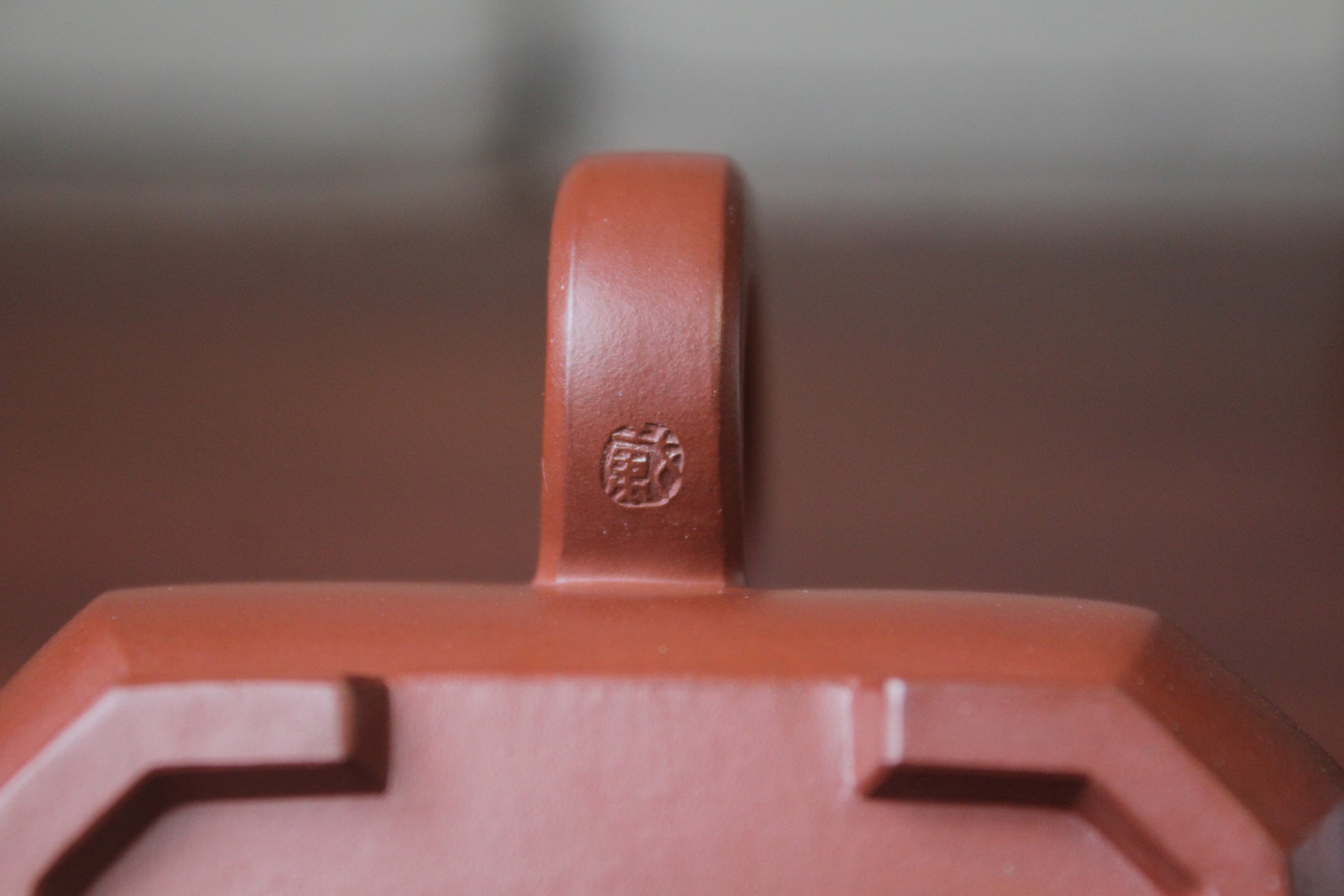 A mark of the collectible teapot from teapot artist on the table