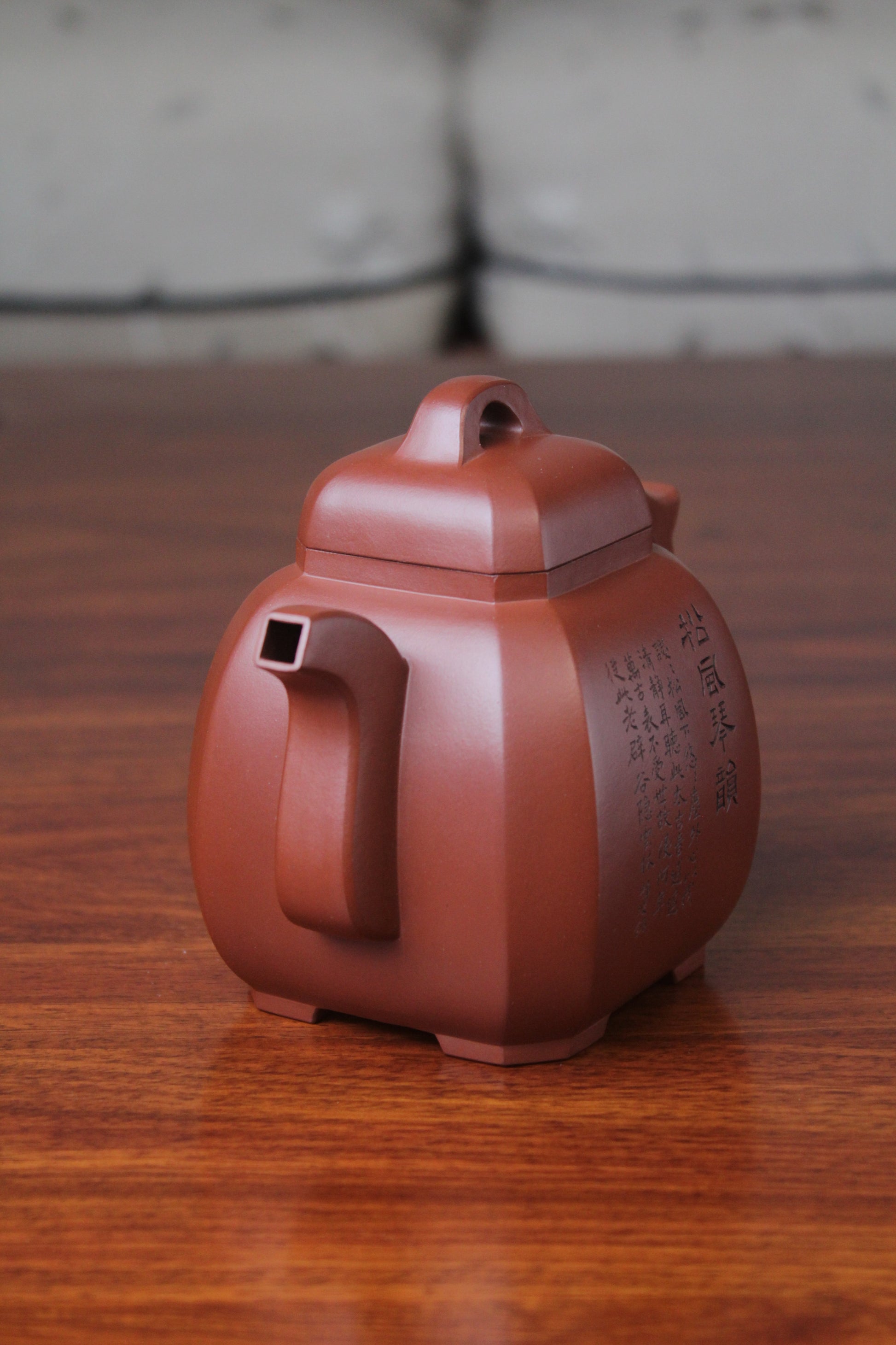right of the collectible teapot from teapot artist on the table