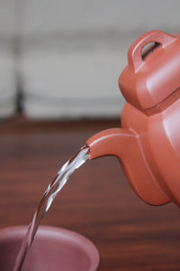 pour of collectible teapot from teapot artist on the table