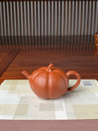 collectible teapot named pumpkin on the table