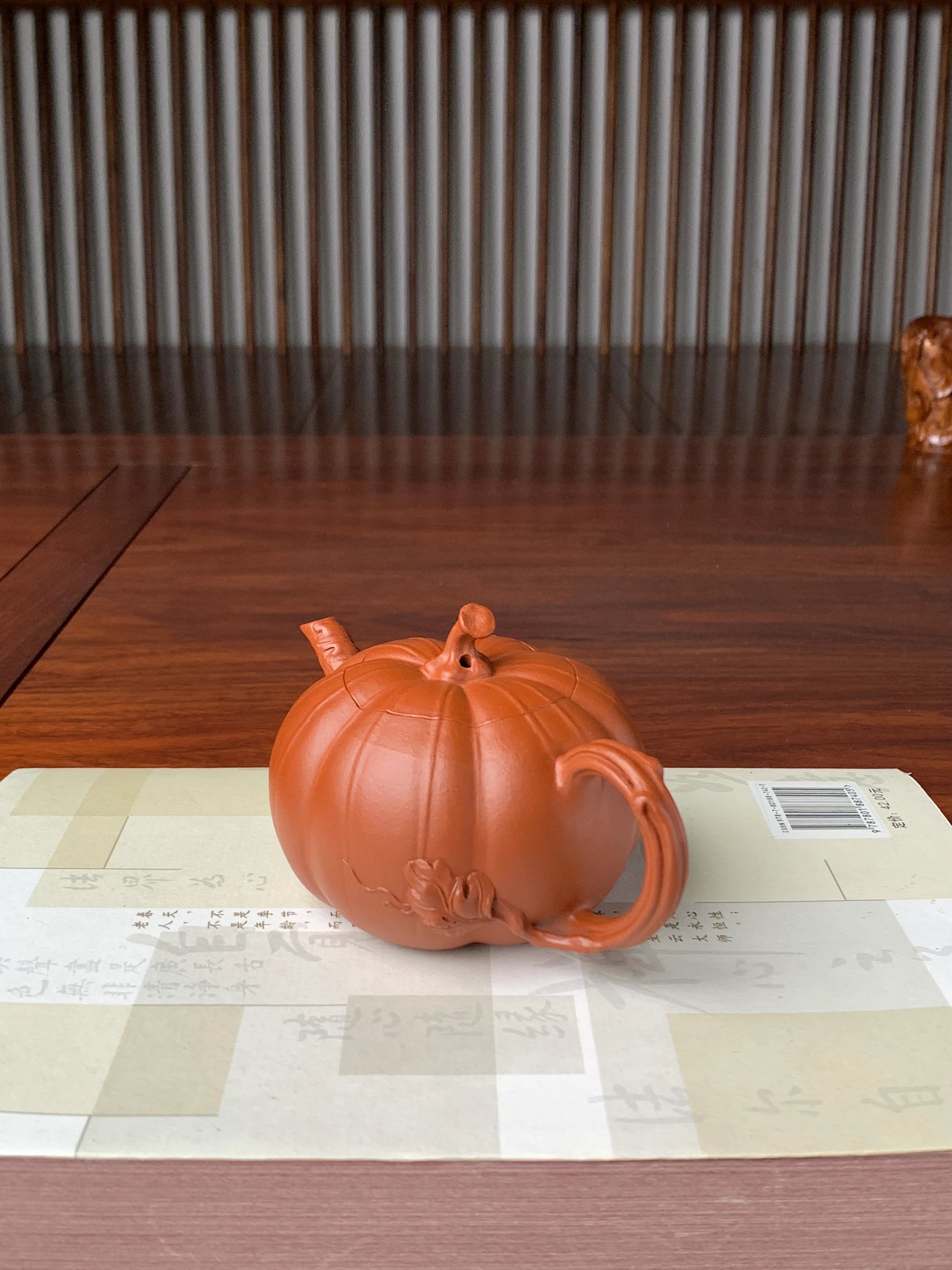 left view of the collectible teapot named pumpkin on the table