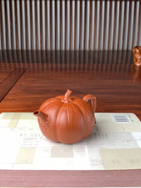 right view of the collectible teapot named pumpkin on the table