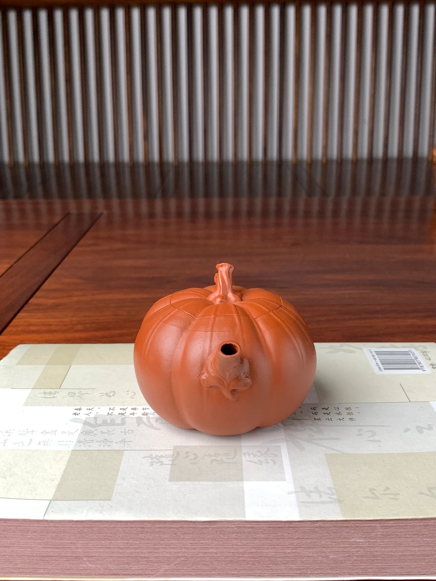 front view of the collectible teapot named pumpkin on the table