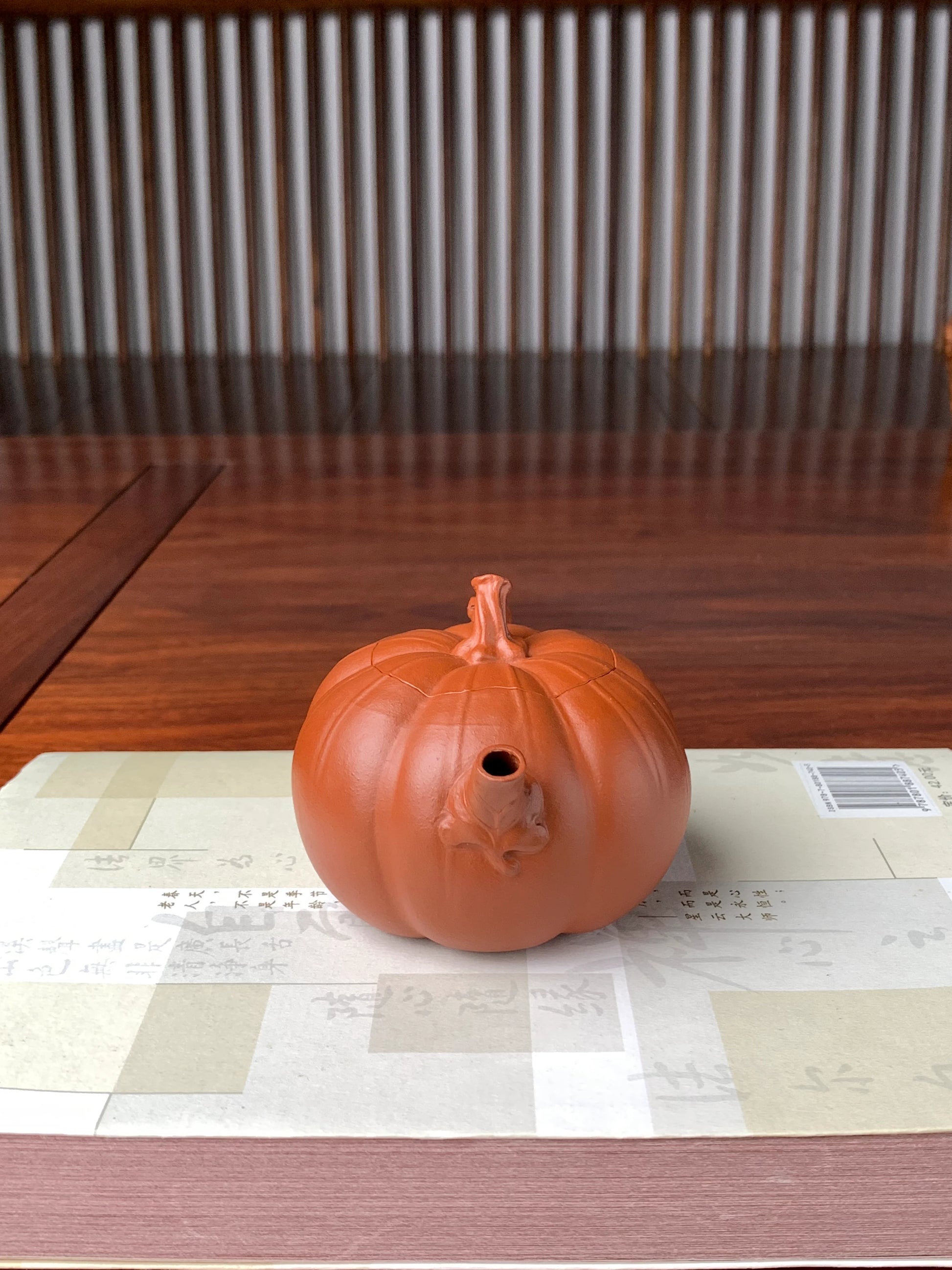 front view of the collectible teapot named pumpkin on the table