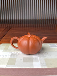 back view of the collectible teapot named pumpkin on the table