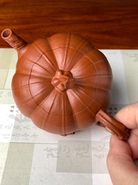 overhead view of the collectible teapot named pumpkin on the table