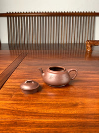 the lid and the teapot body on the table