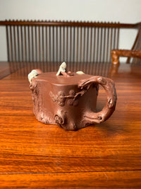 Decorative detail of pine branches on teapot