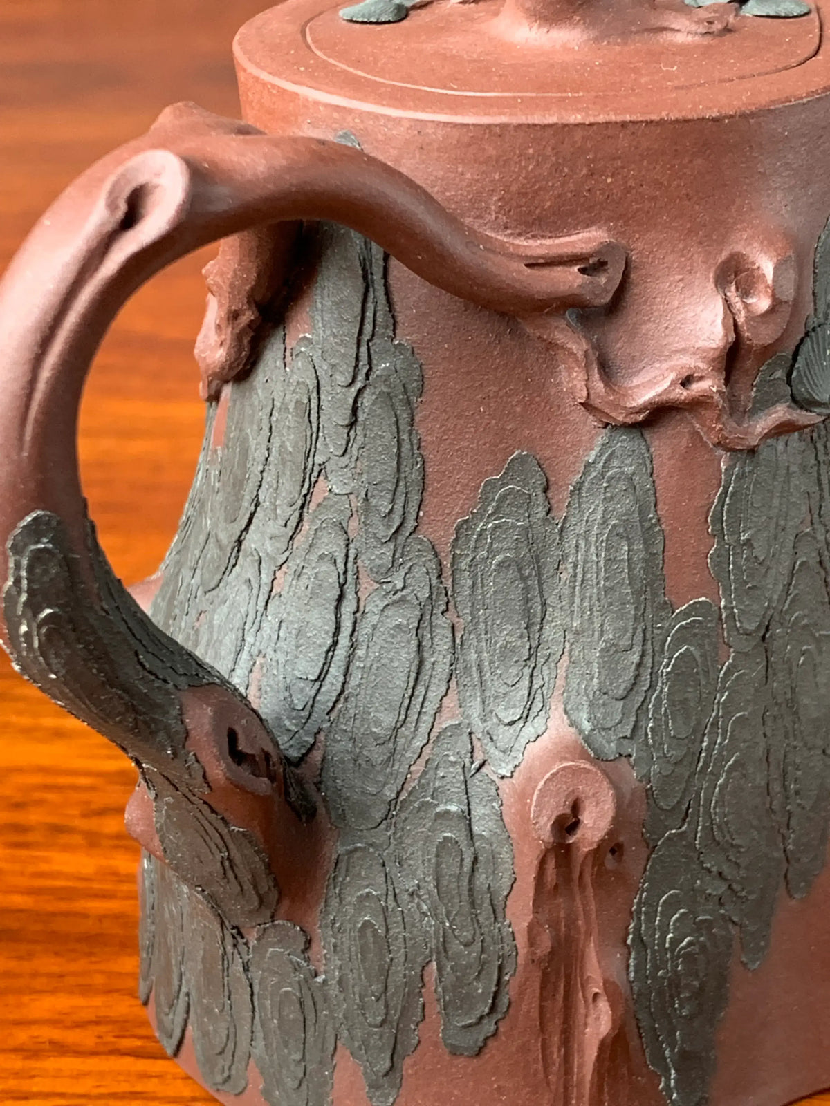 A close-up view of the details of the pine bark pattern on the teapot