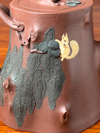 A close-up view of the details of the squirrel pattern on the teapot