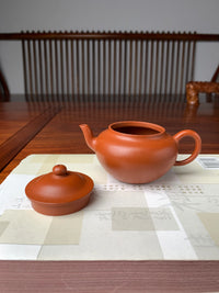 the front view of the yixing teapot handmade with zhuni clay