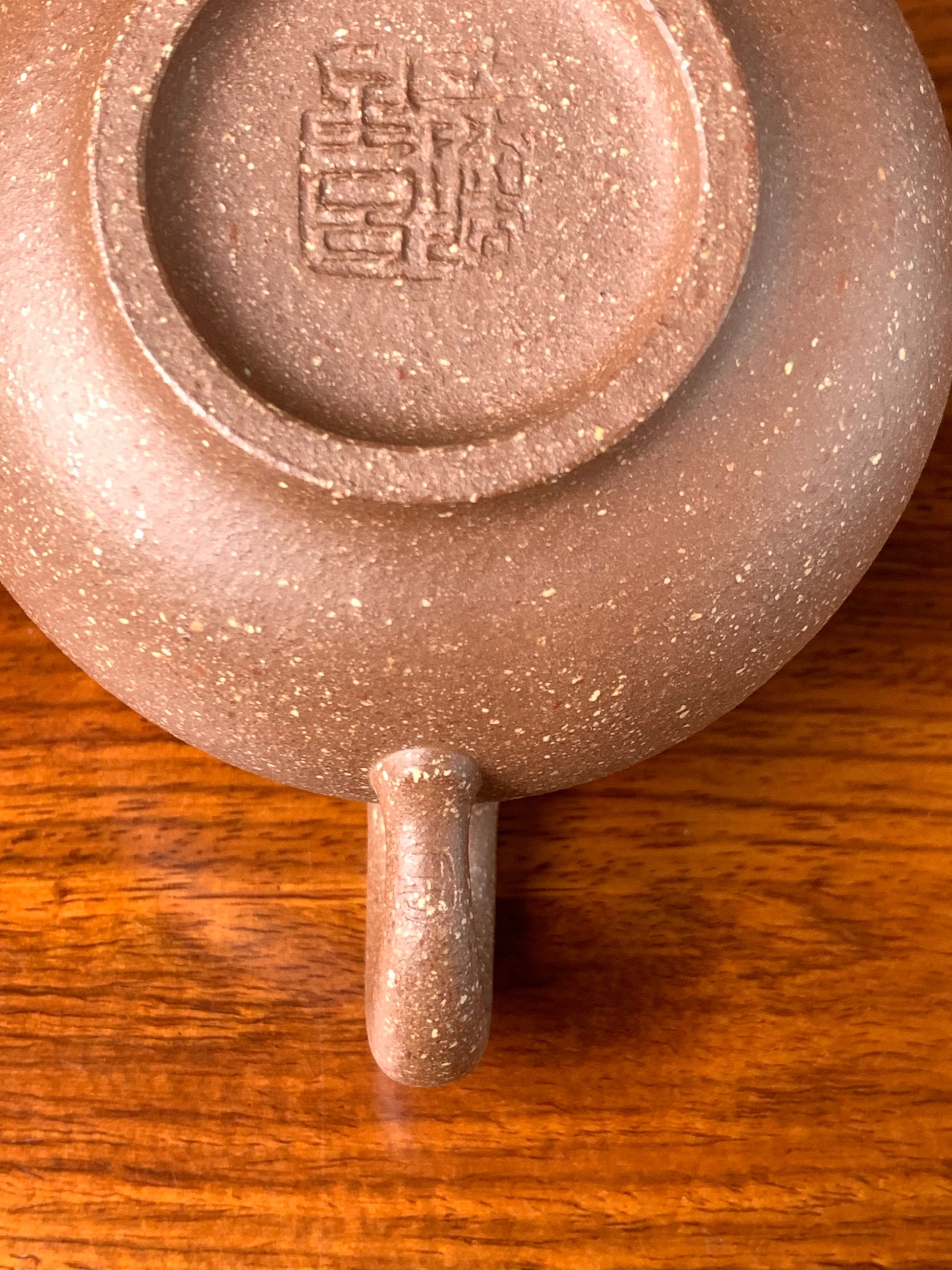 There is an artist's seal on the teapot handle.