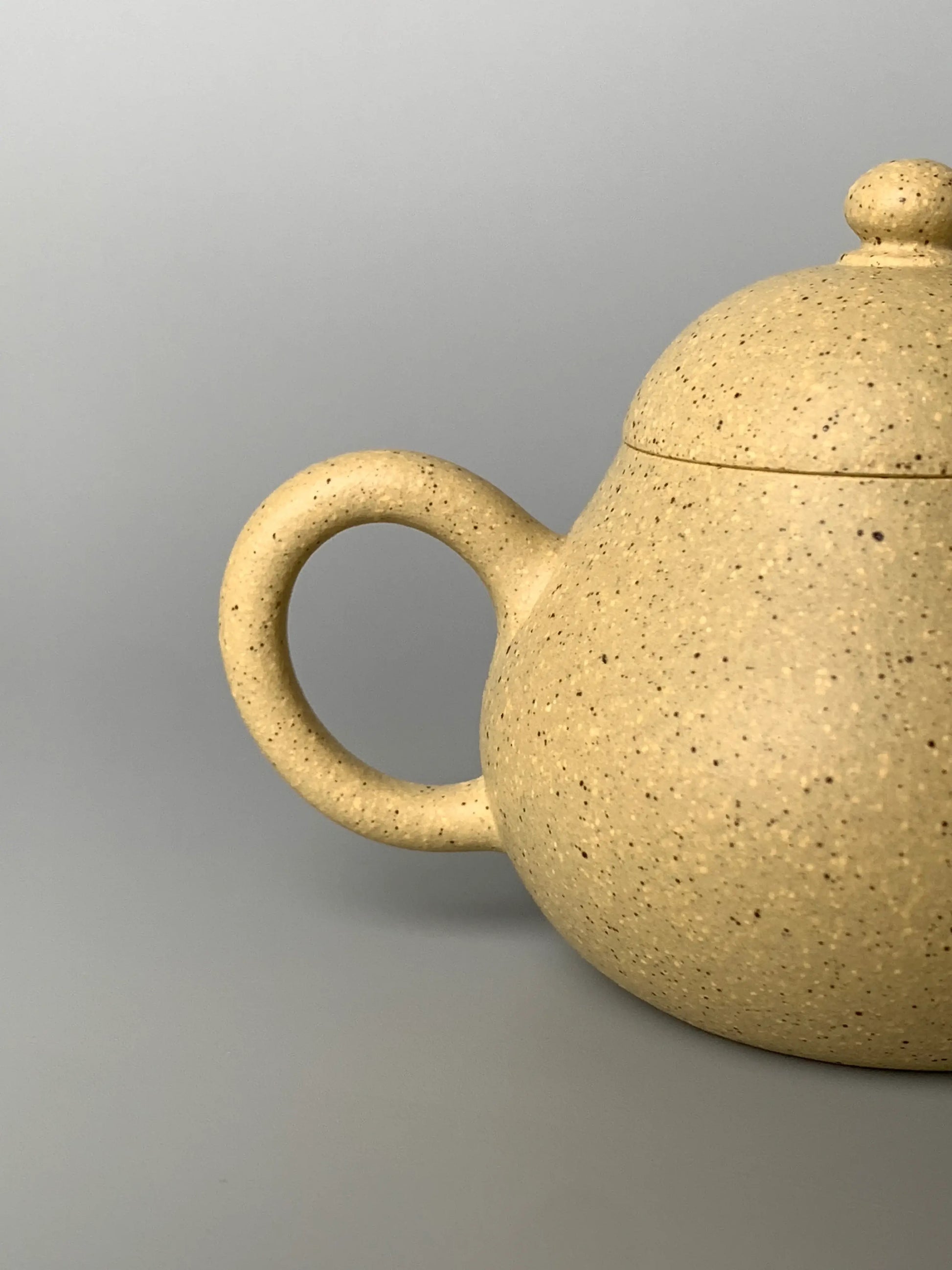 This is a close-up photo of the handle of a Yixing teapot