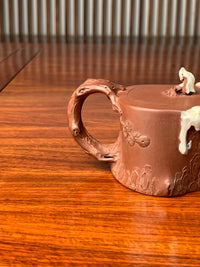 collectible teapot with branch-shaped handle
