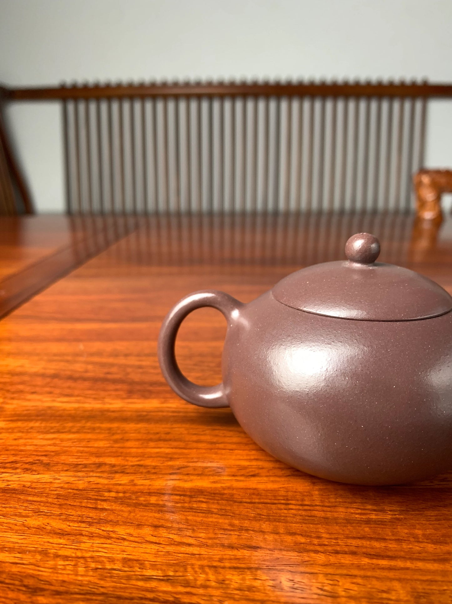 The curve of the zisha teapot handle is elegant