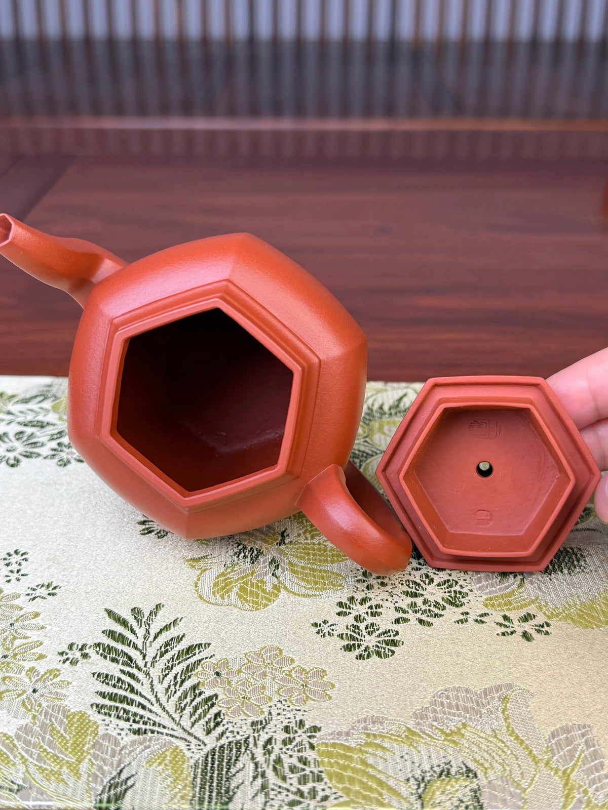 The lid and the opening (mouth) of the teapot.