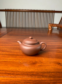 handmade yixing zisha clay teapot named yong fu lian zi on the table
