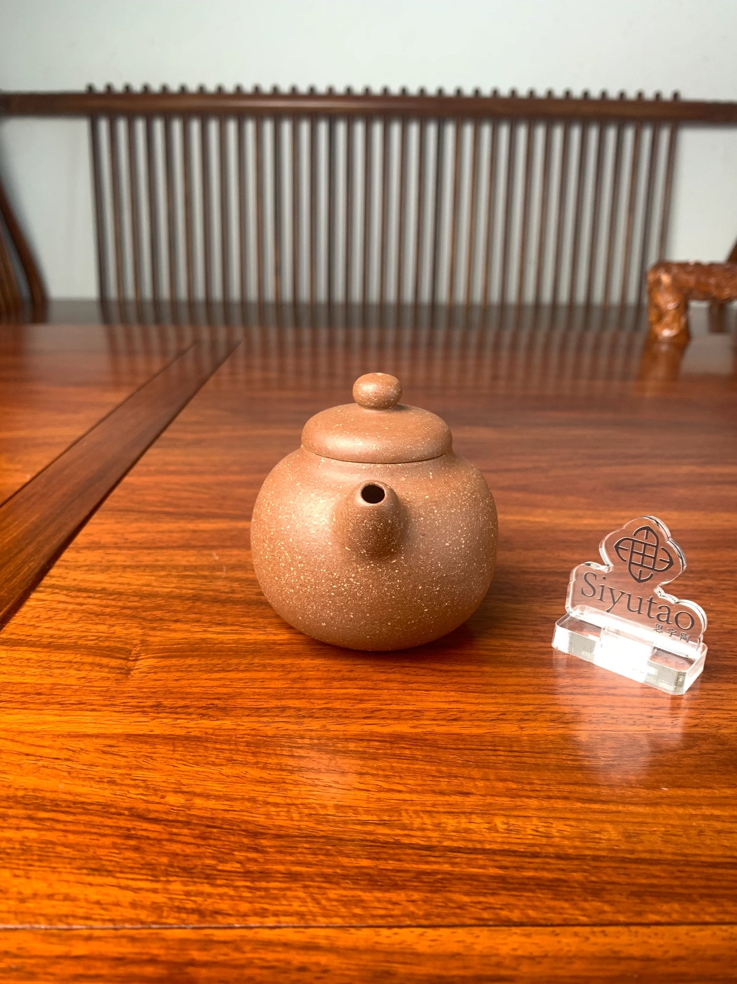 the front view of handmade yixing teapot on the table