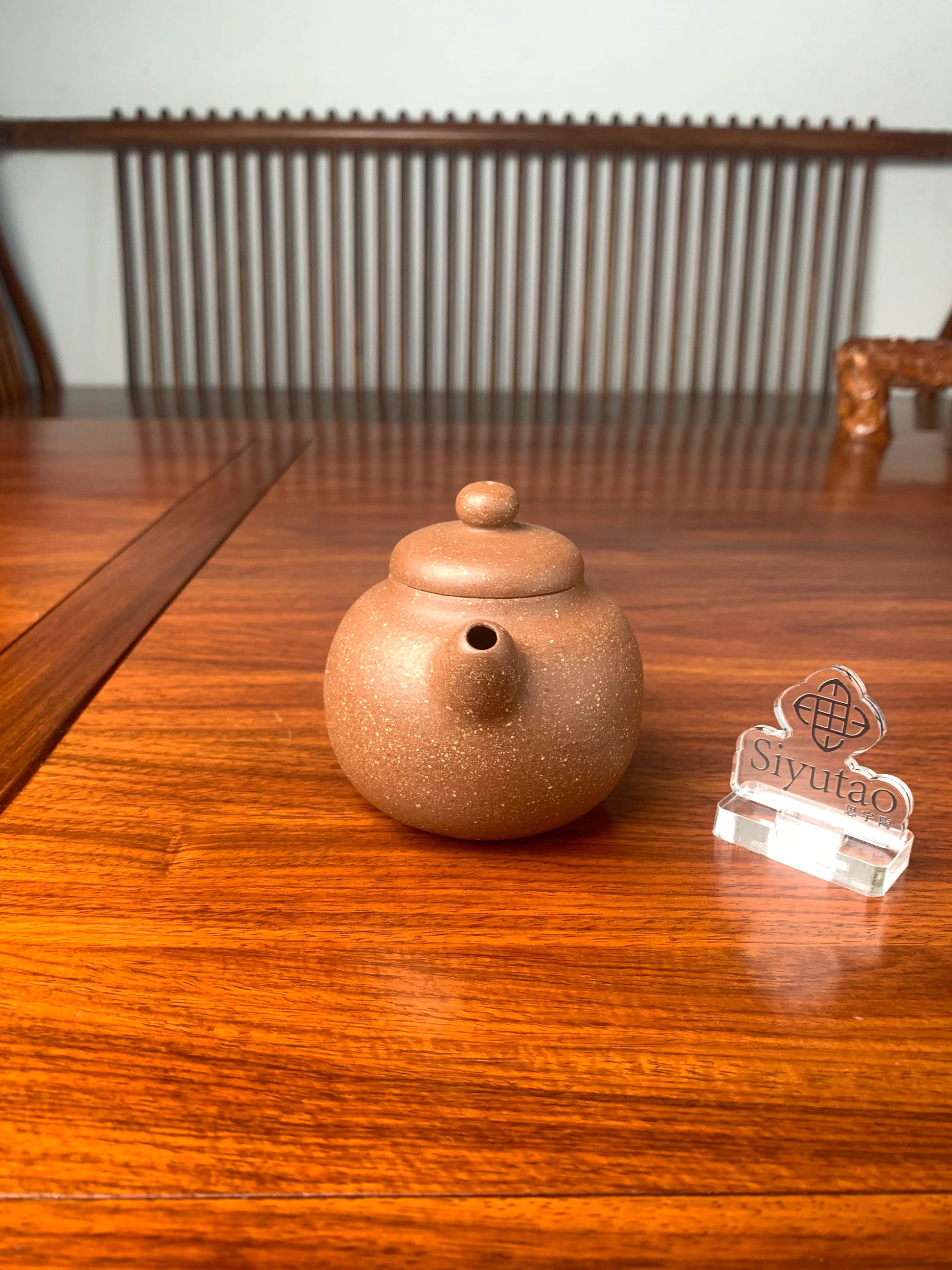 the front view of handmade yixing teapot on the table