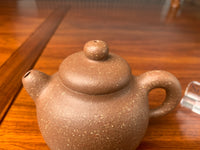 the detail of the handmade yixing teapot on the table