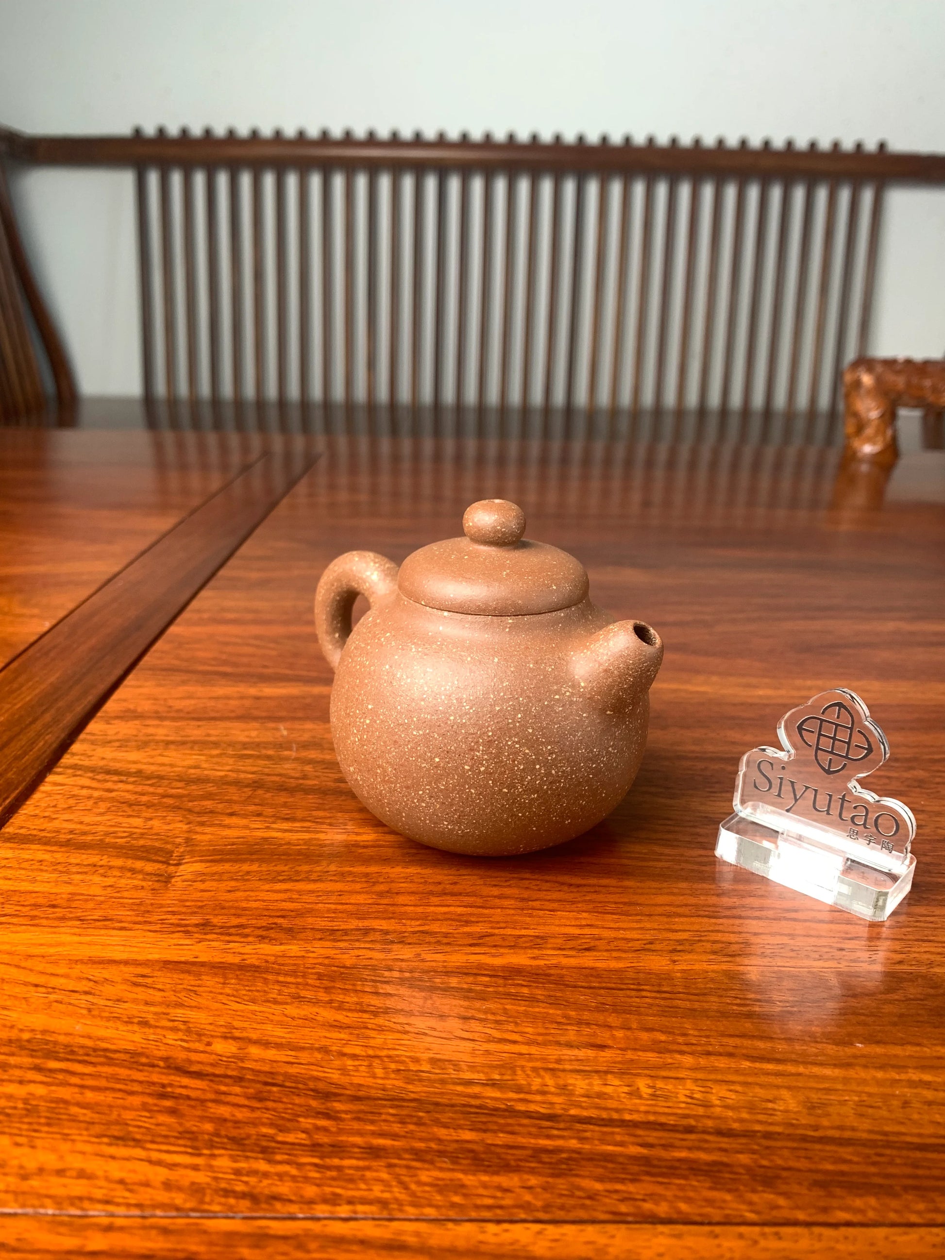 the left view of the handmade yixing teapot on the table