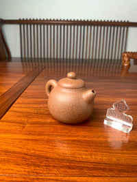 the left view of the handmade yixing teapot on the table
