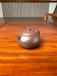 the right view of handmade yixing teapot named xi shi on the table