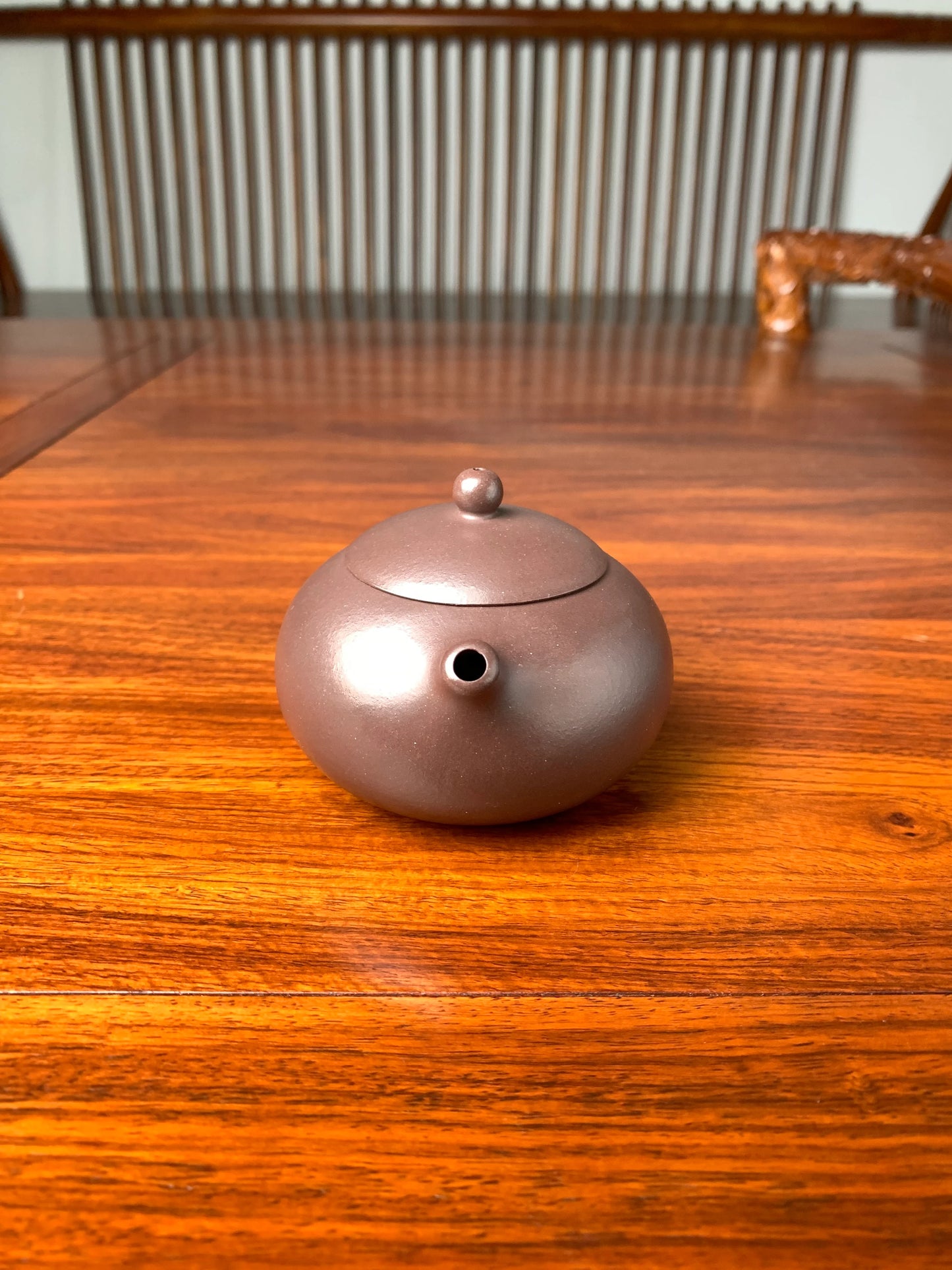 the front view of handmade yixing teapot named xi shi on the table