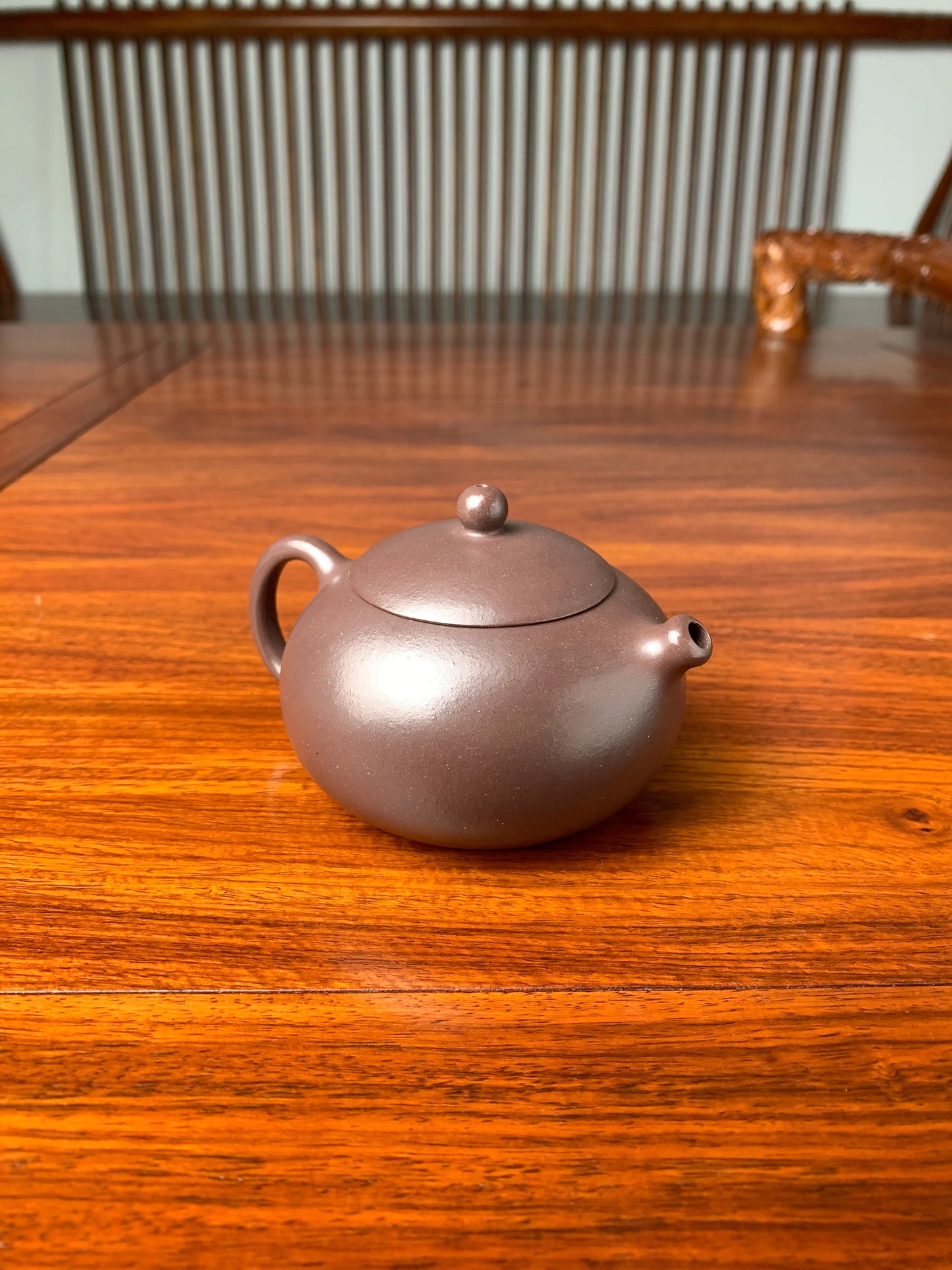 the left view of handmade yixing teapot named xi shi on the table