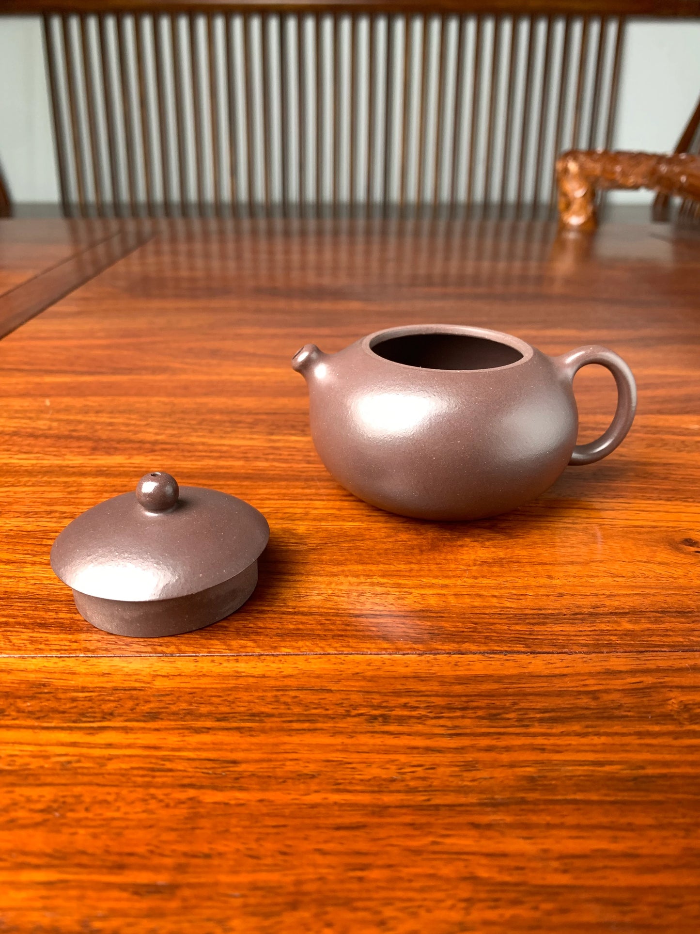 The lid and body of the teapot placed on the table