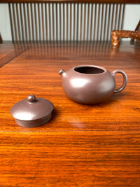 The lid and body of the teapot placed on the table