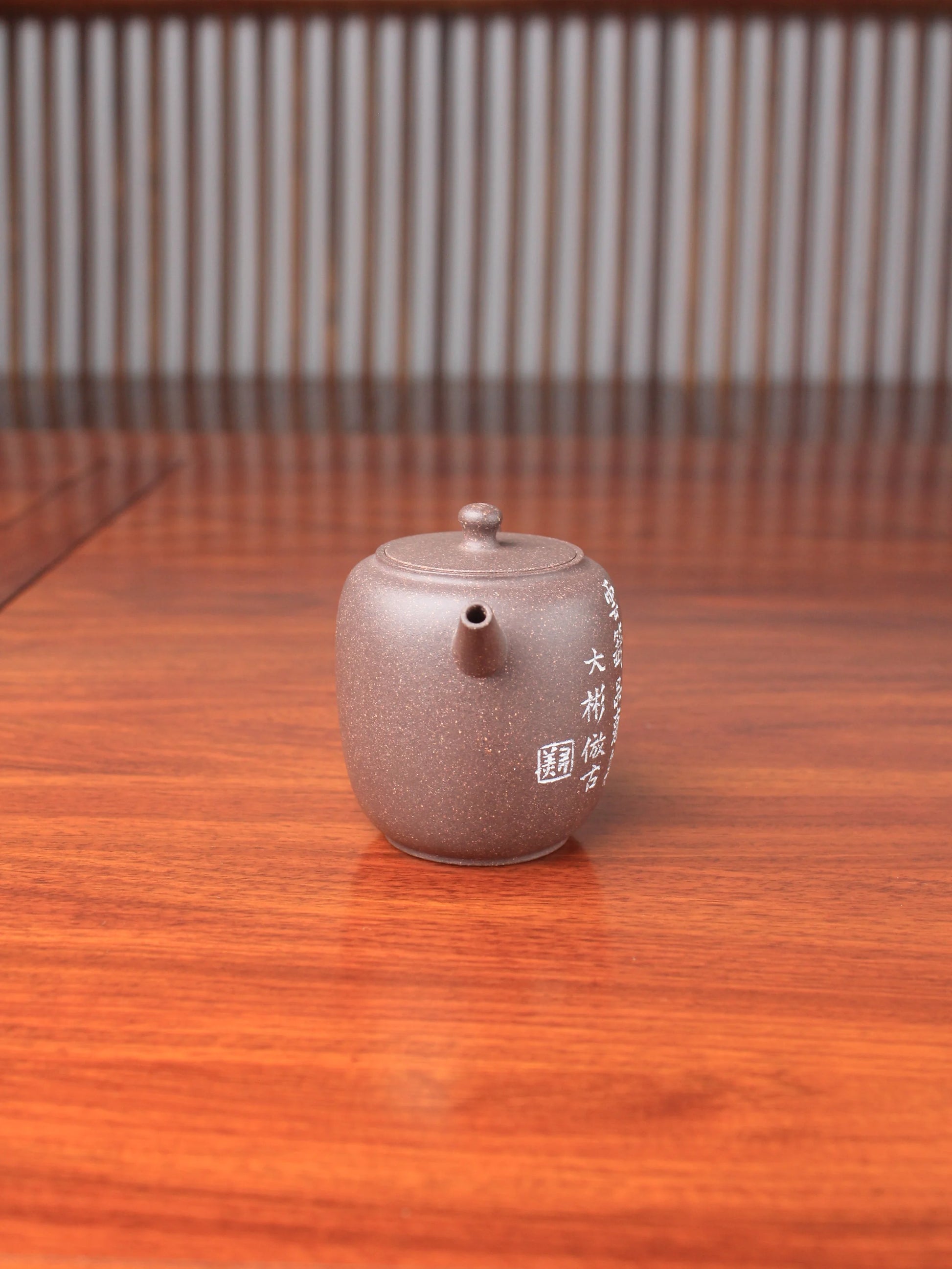 handmade yixing teapot named da bin lian zi on the table front view