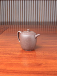 handmade yixing teapot named da bin lian zi on the table left view