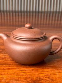the teapot body of the handmade yixing clay teapot named yong fu lian zi