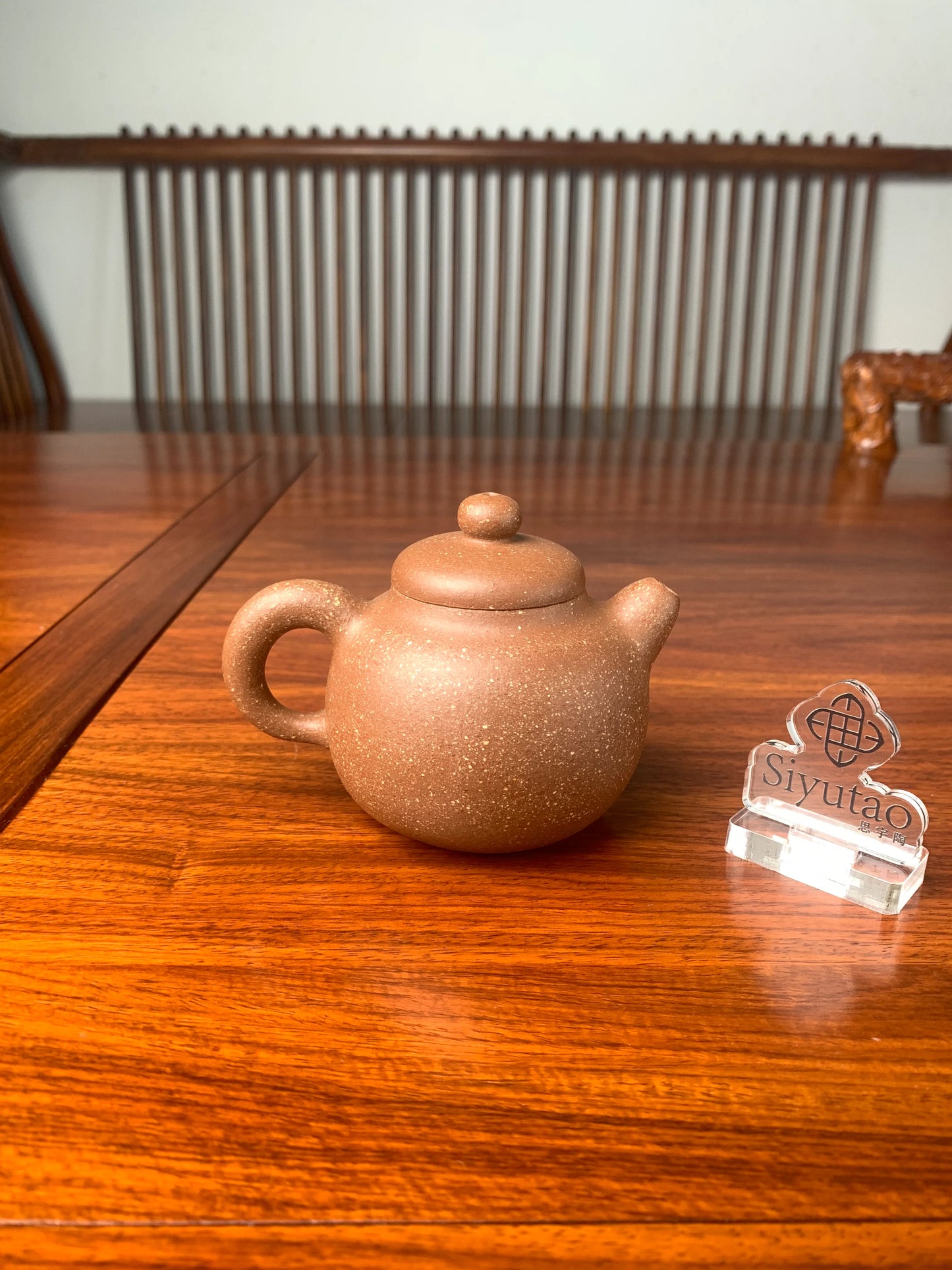 the handmade yixing teapot on the table back view